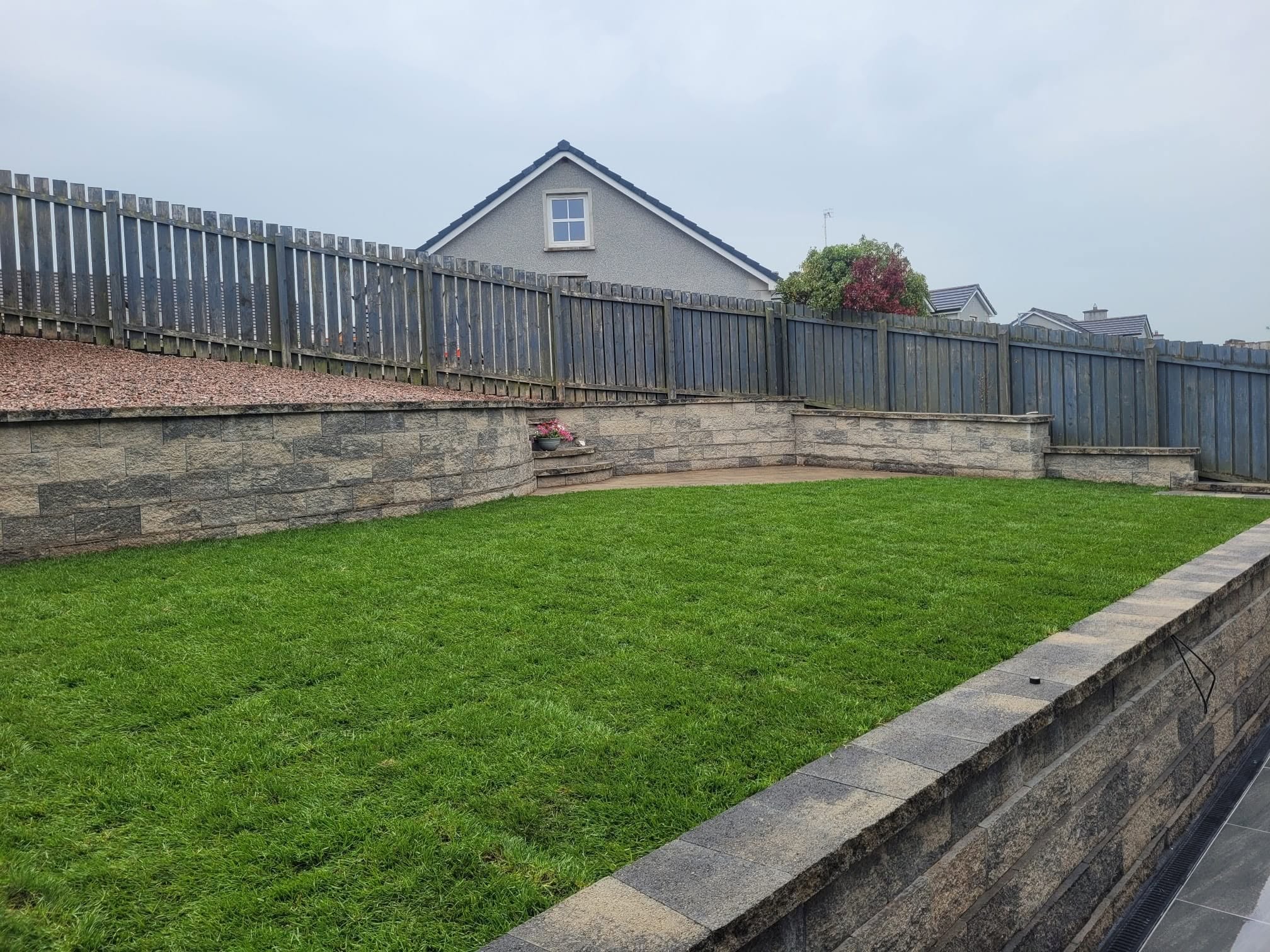 Tiered back garden with steps to stone area at the top