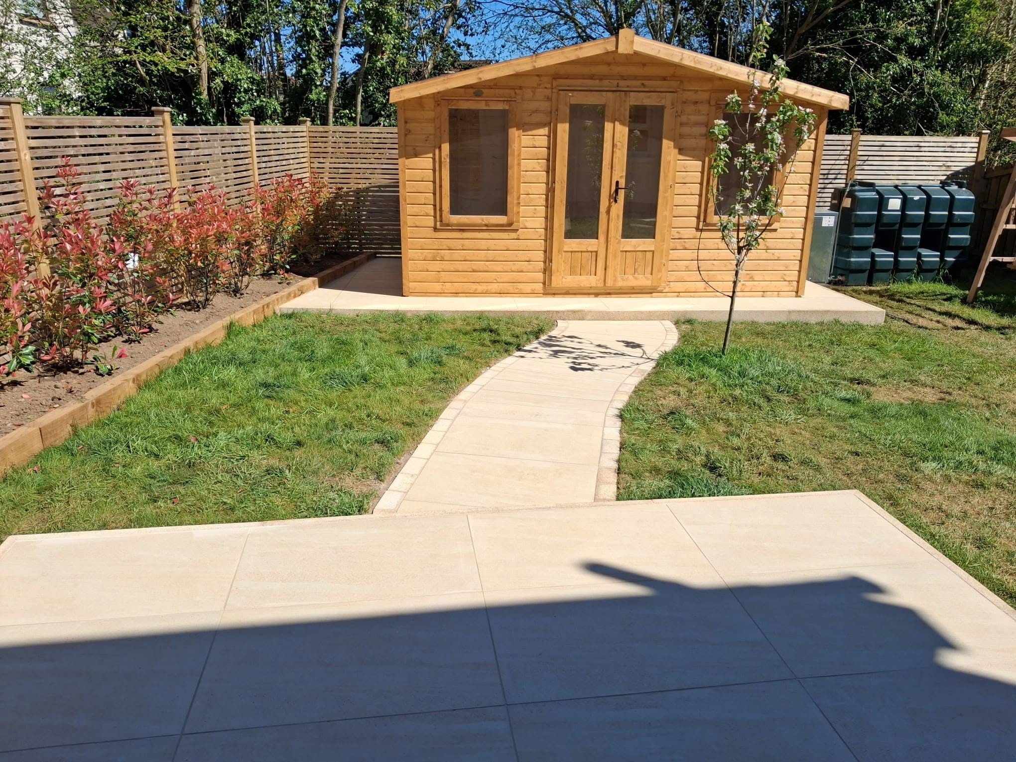 Wooden cabin with paved walkway to patio